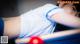 A woman laying on top of a pool table.