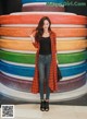 A woman standing in front of a colorful wall.