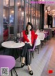 A woman sitting at a table in a restaurant.