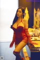 A woman in a red lingerie posing in front of a mirror.