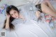 A woman laying on a bed with stuffed animals.