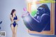 A woman in a blue bathing suit taking a selfie with a gorilla.