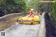 A group of people riding on top of a yellow tube down a river.