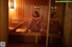 A woman sitting on a bench in a sauna.