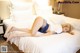 A woman laying on a bed in a hotel room.