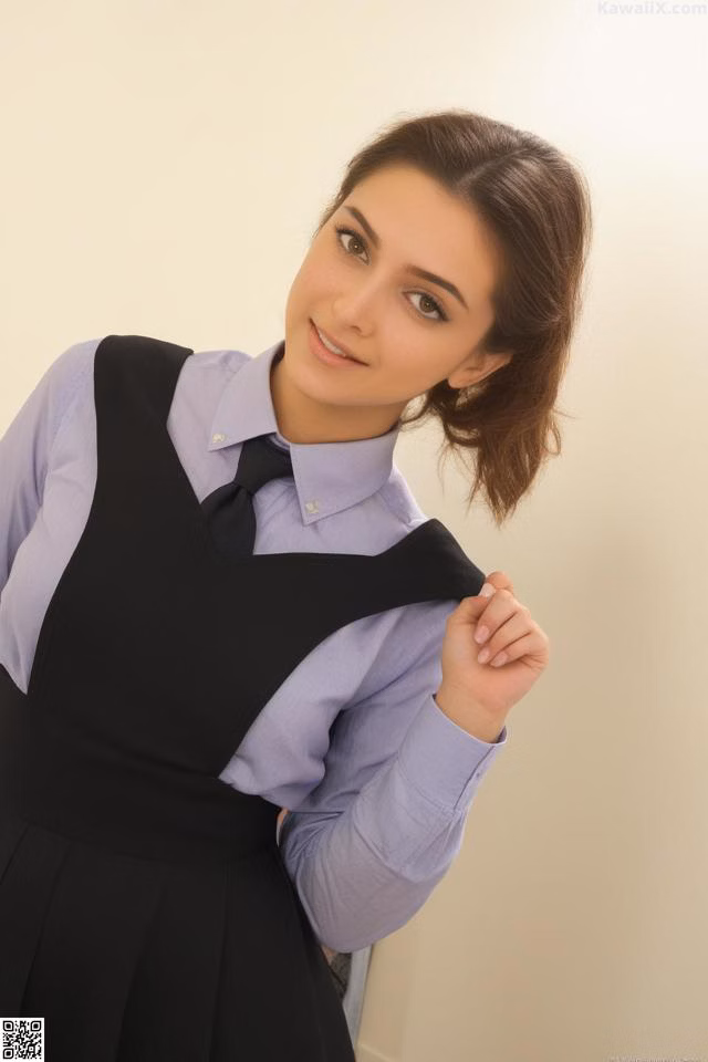 A woman in a black dress and a purple shirt.